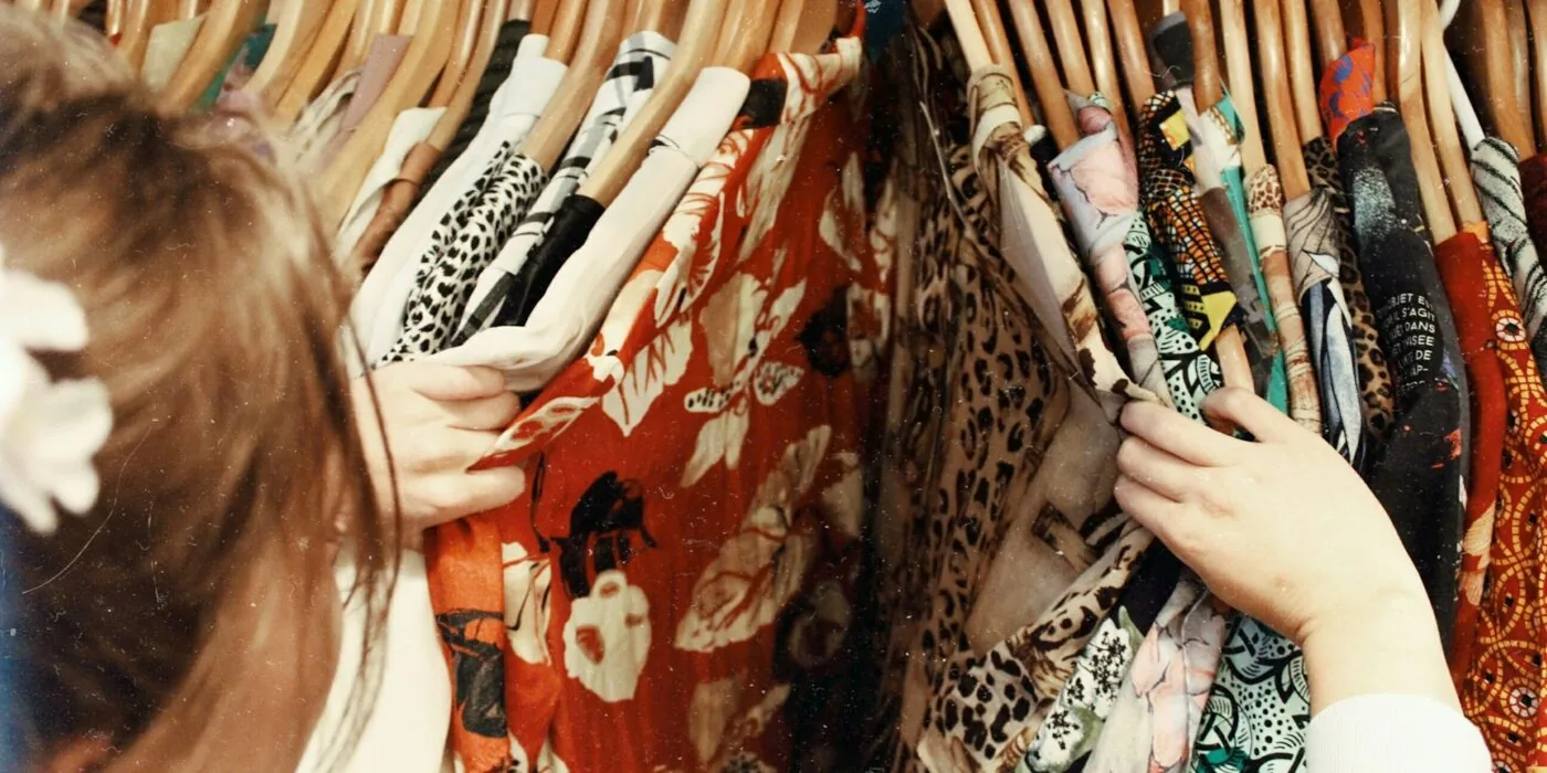 Person at store counter processing clothing return with staff member