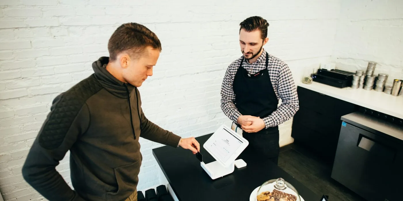 Person examining furniture purchase receipt and invoice after delivery, comparing prices and costs