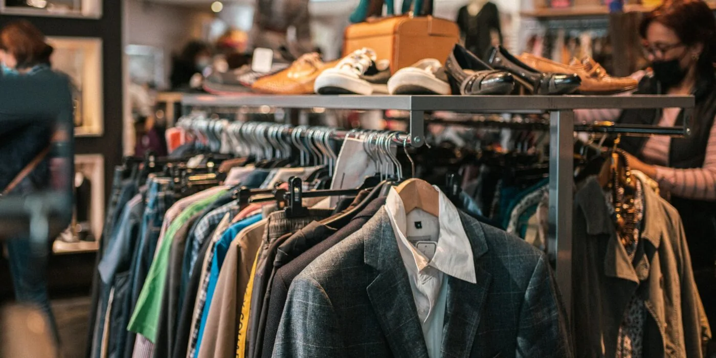 Woman shopping for clothes in retail store during seasonal sale event